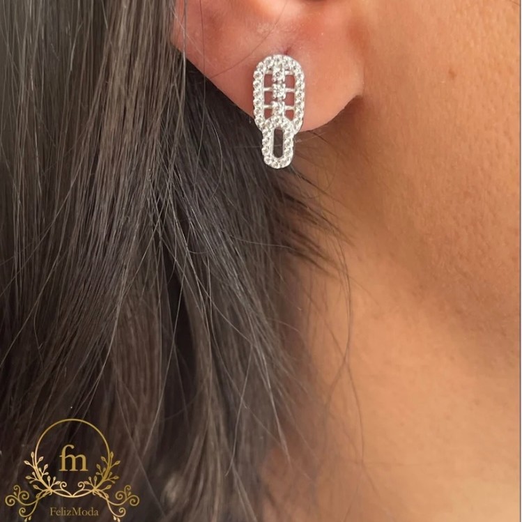 Two connected oval silver earrings with three stones